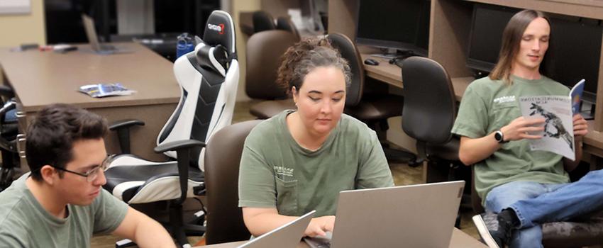 Students working in classroom on laptops.