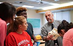 Dr. Phil Carr showing skull in class